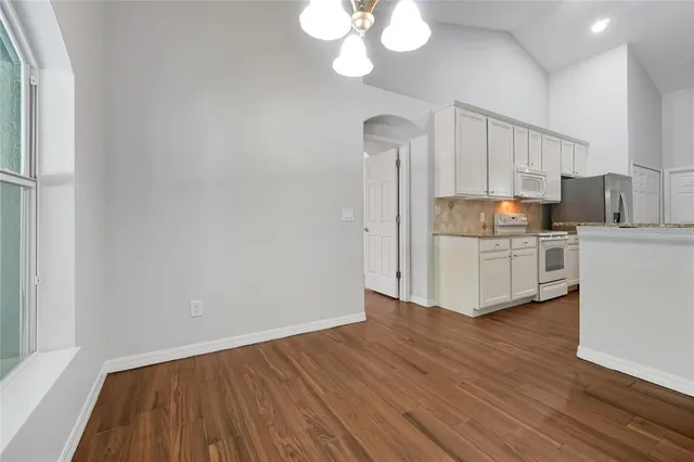 a view of a kitchen with wooden floor