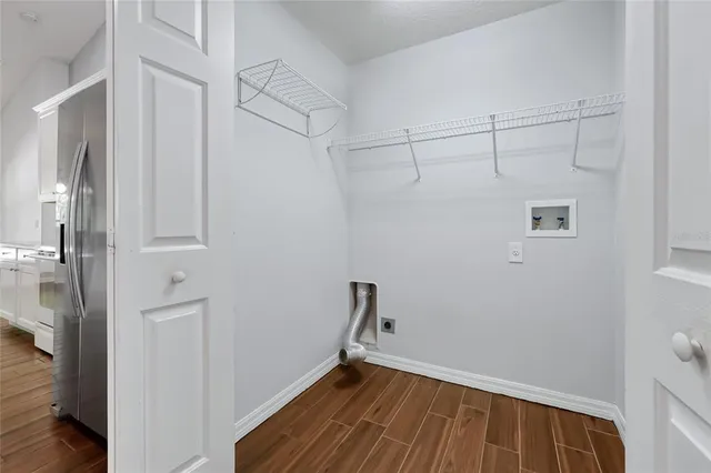 a view of a room with wooden floor