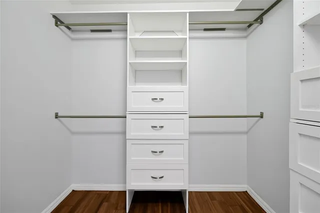 a view of walk in closet with empty racks