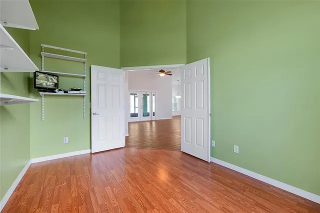 a view of a room with wooden floor and an entryway