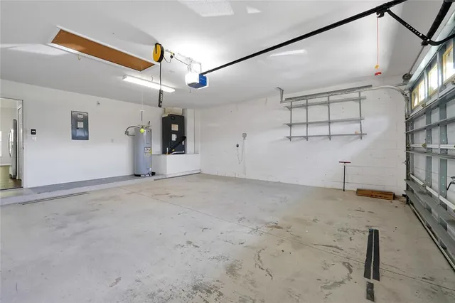 a view of a livingroom with a fan & a window