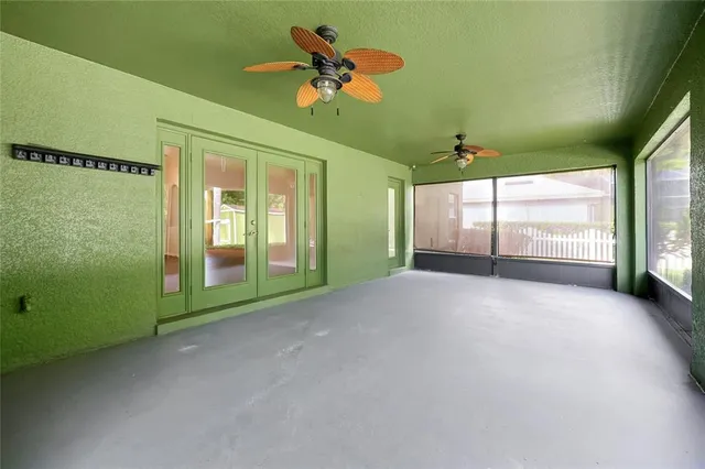 a view of a deck with a small yard and large trees