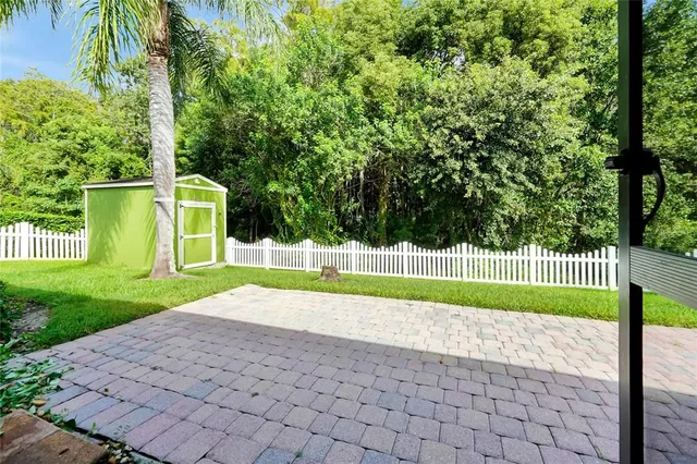 a view of backyard with swimming pool
