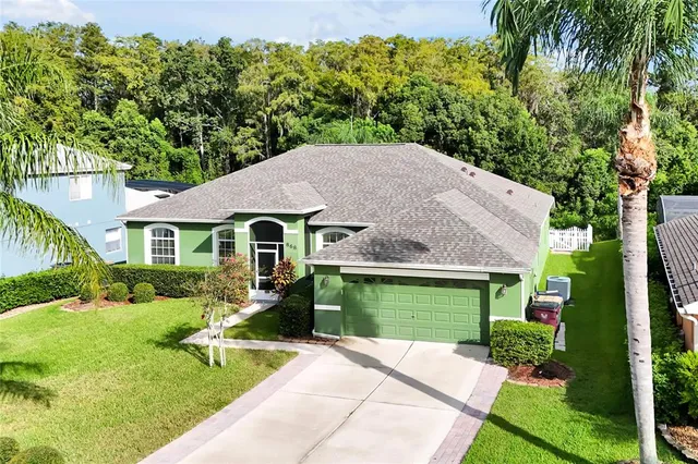 an aerial view of a house with a yard and potted plants