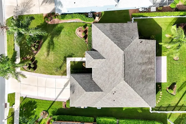 an aerial view of a houses with a lake