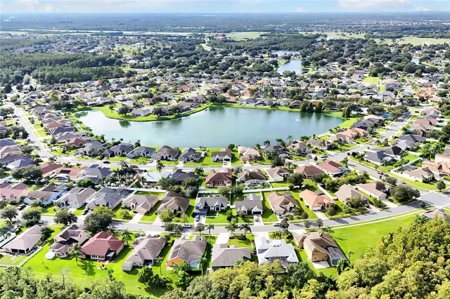 an aerial view of a houses with a lake view