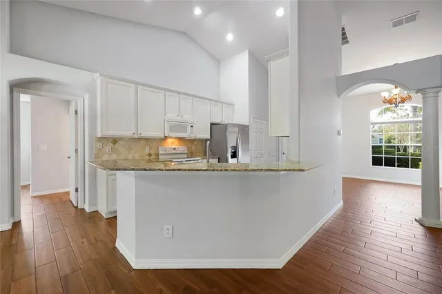 a kitchen with counter top space and window