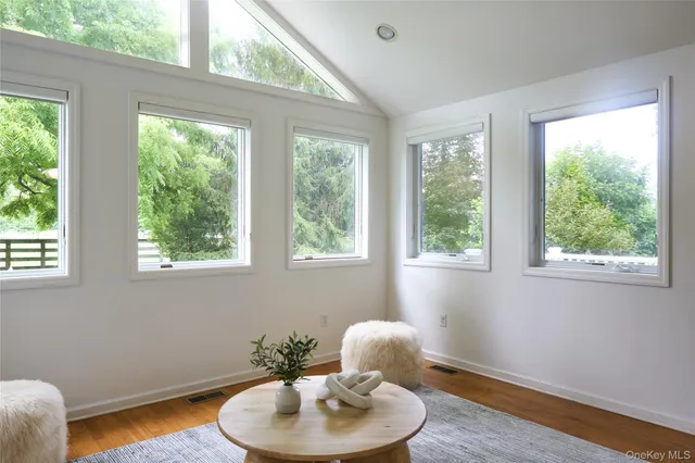 a dining room with a window and wooden floor