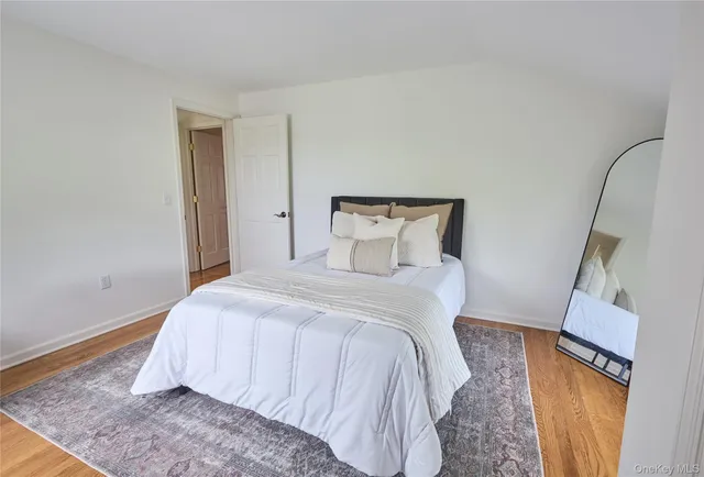 a bedroom with a bed and a mirror