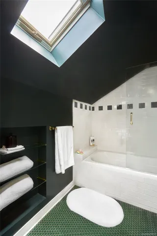 a bathroom with a toilet and a tub