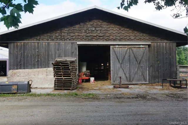 a view of a house with a small yard and wooden fence