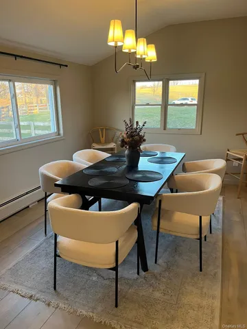 a view of a dining room with furniture window and outside view