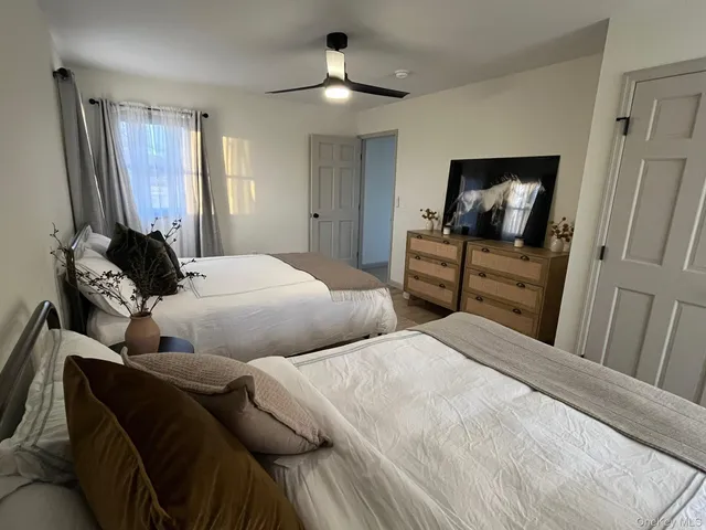 a bedroom with a bed and a television