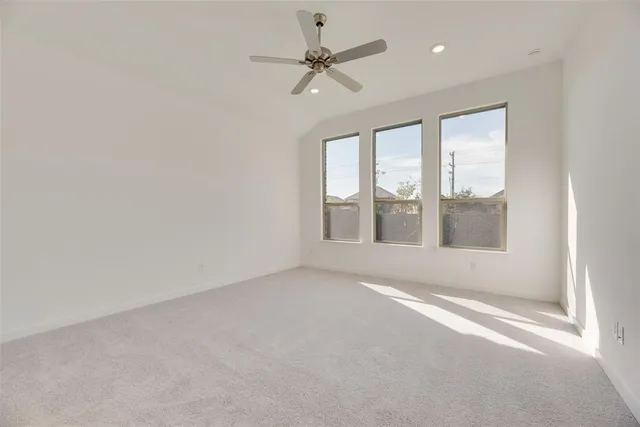 a kitchen with a sink a stove a refrigerator and white cabinets