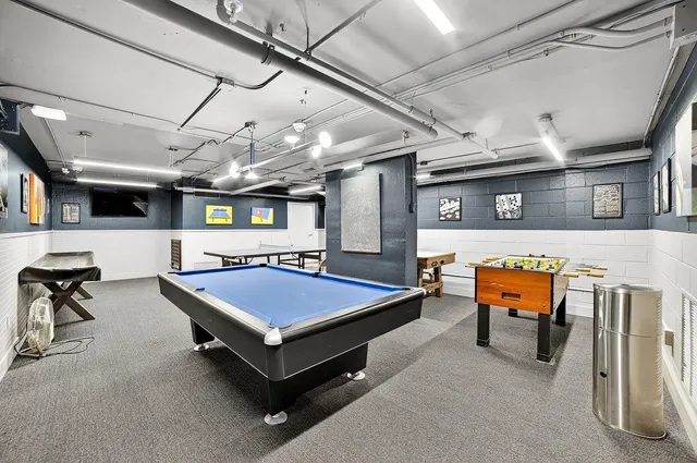 a room with a large mirror and a view of living room