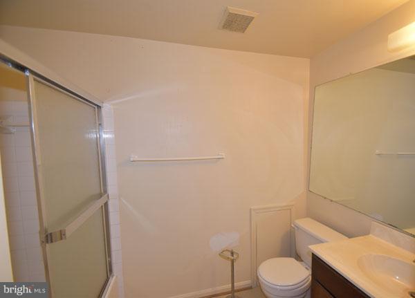 16 Tabiona Court Silver Spring, MD 20906 - Photo 9 of 12 a white toilet sitting next to a shower curtain