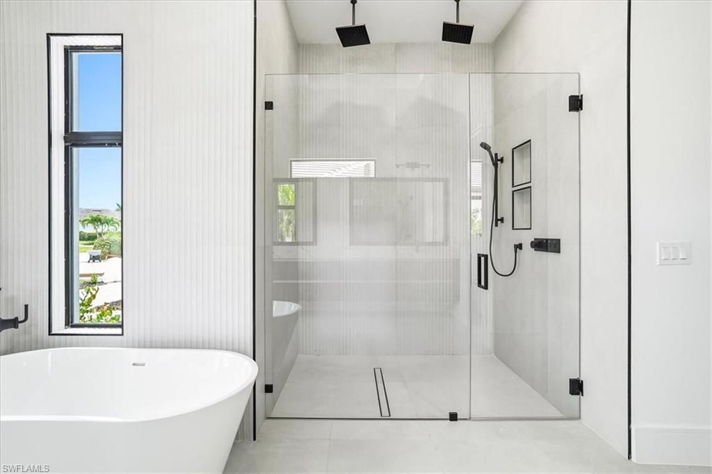 14318 Charthouse Circle Naples, FL 34114 - Photo 11 of 36 a bathroom with a bath tub