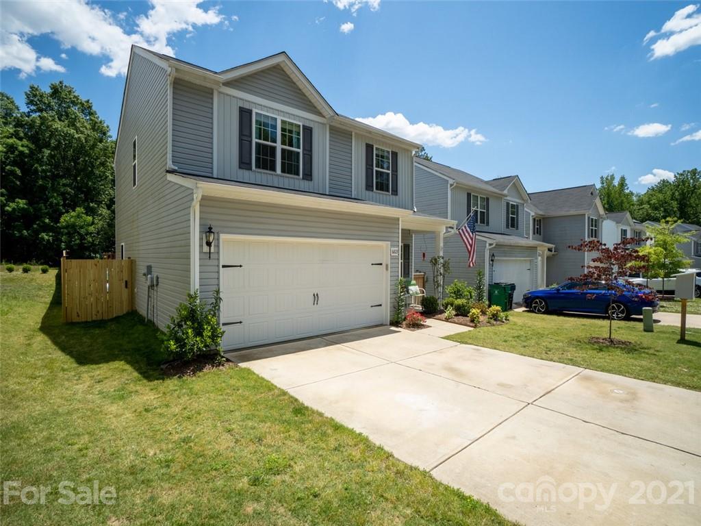 6823 Ware Road Charlotte, NC 28212 - Photo 2 of 47 a front view of a house with a yard and garage