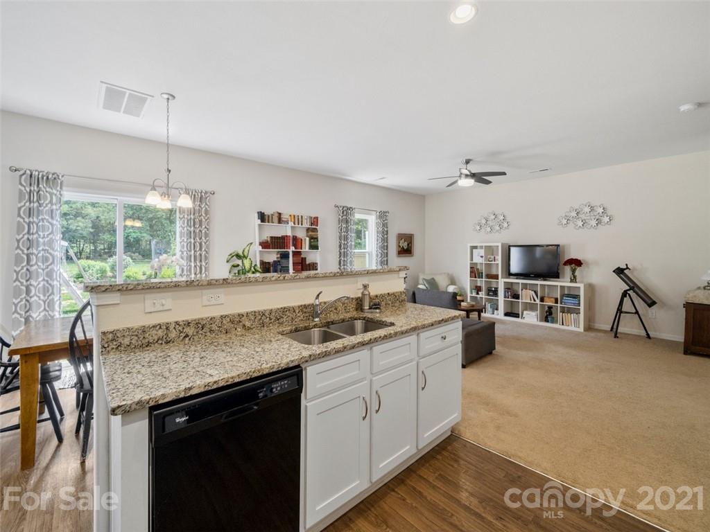 6823 Ware Road Charlotte, NC 28212 - Photo 11 of 47 a kitchen with stainless steel appliances granite countertop a sink stove and cabinets