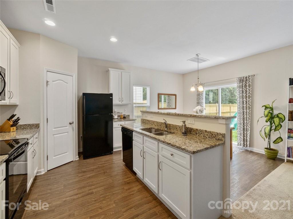 6823 Ware Road Charlotte, NC 28212 - Photo 13 of 47 a kitchen with stainless steel appliances granite countertop a refrigerator and a sink