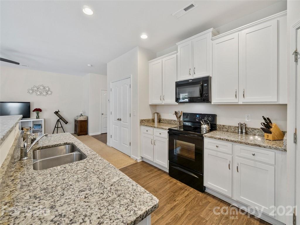 6823 Ware Road Charlotte, NC 28212 - Photo 14 of 47 a kitchen with granite countertop a sink stove and cabinets