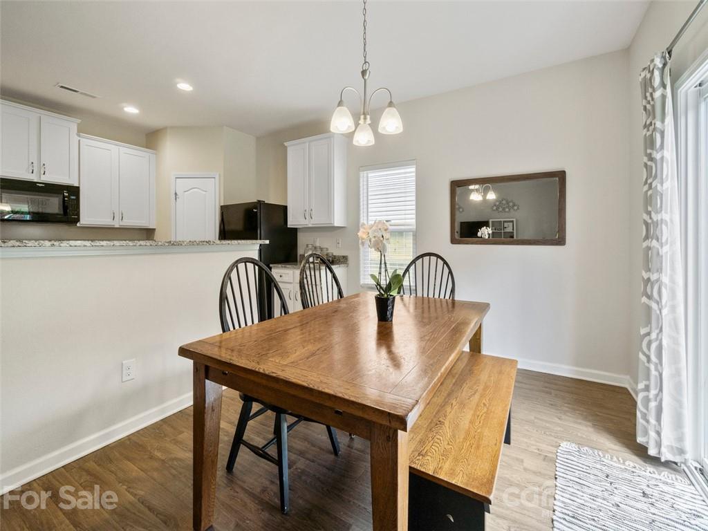 6823 Ware Road Charlotte, NC 28212 - Photo 15 of 47 a view of a dining room with furniture and a chandelier