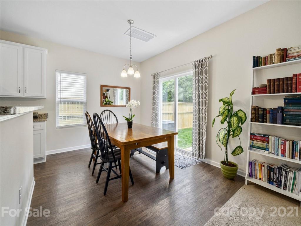 6823 Ware Road Charlotte, NC 28212 - Photo 16 of 47 a view of a dining room with furniture window and wooden floor