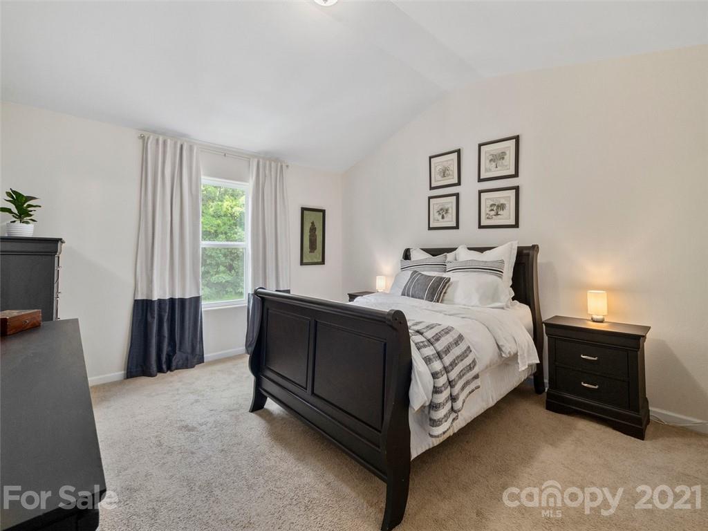 6823 Ware Road Charlotte, NC 28212 - Photo 18 of 47 a bedroom with a bed and a couch