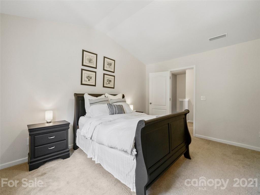 6823 Ware Road Charlotte, NC 28212 - Photo 21 of 47 a bedroom with a bed and painting on the wall