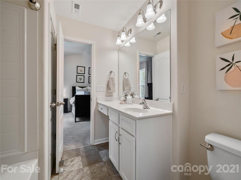 6823 Ware Road Charlotte, NC 28212 - Photo 24 of 47 a bathroom with a sink a toilet and a mirror