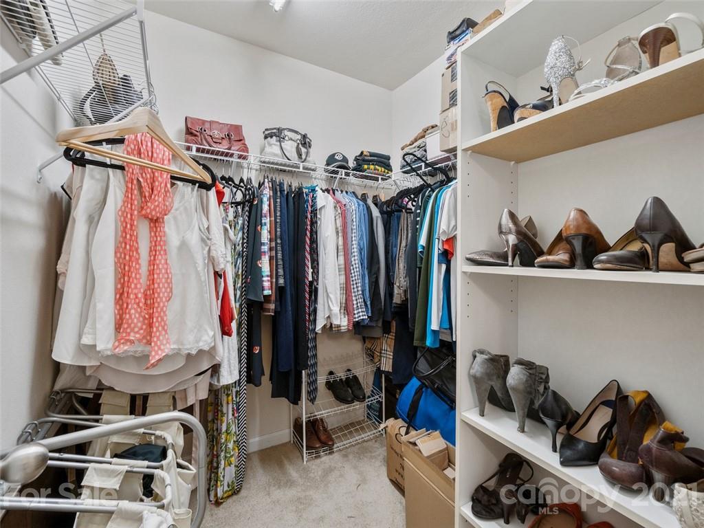 6823 Ware Road Charlotte, NC 28212 - Photo 25 of 47 a view of walk in closet with clothes and shoes