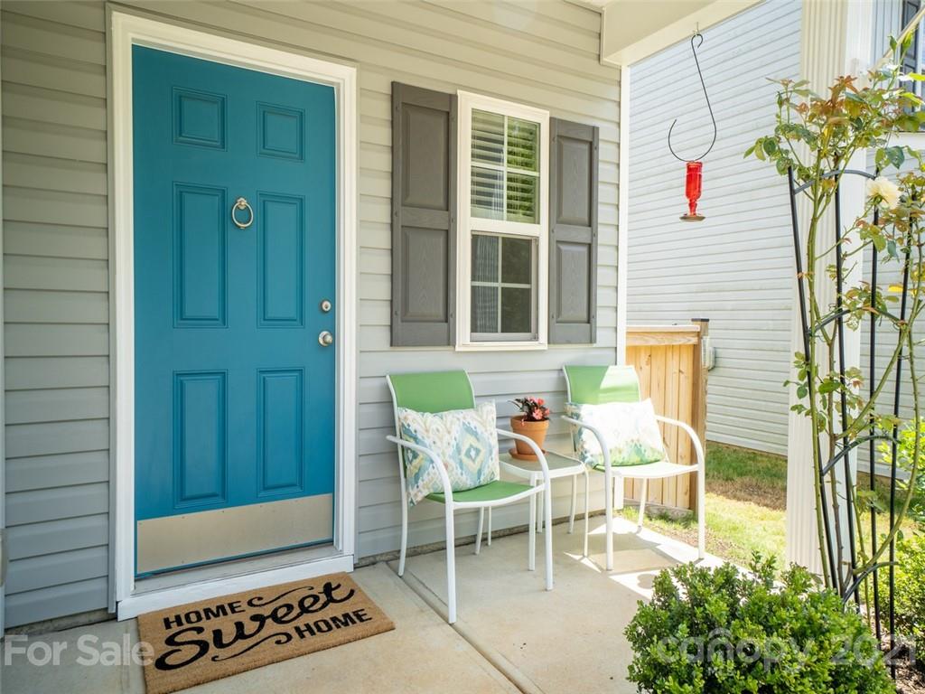6823 Ware Road Charlotte, NC 28212 - Photo 4 of 47 a backyard with table and chairs and potted plants