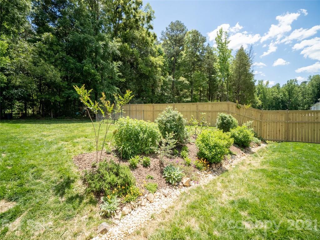 6823 Ware Road Charlotte, NC 28212 - Photo 40 of 47 a view of garden with trees in the background