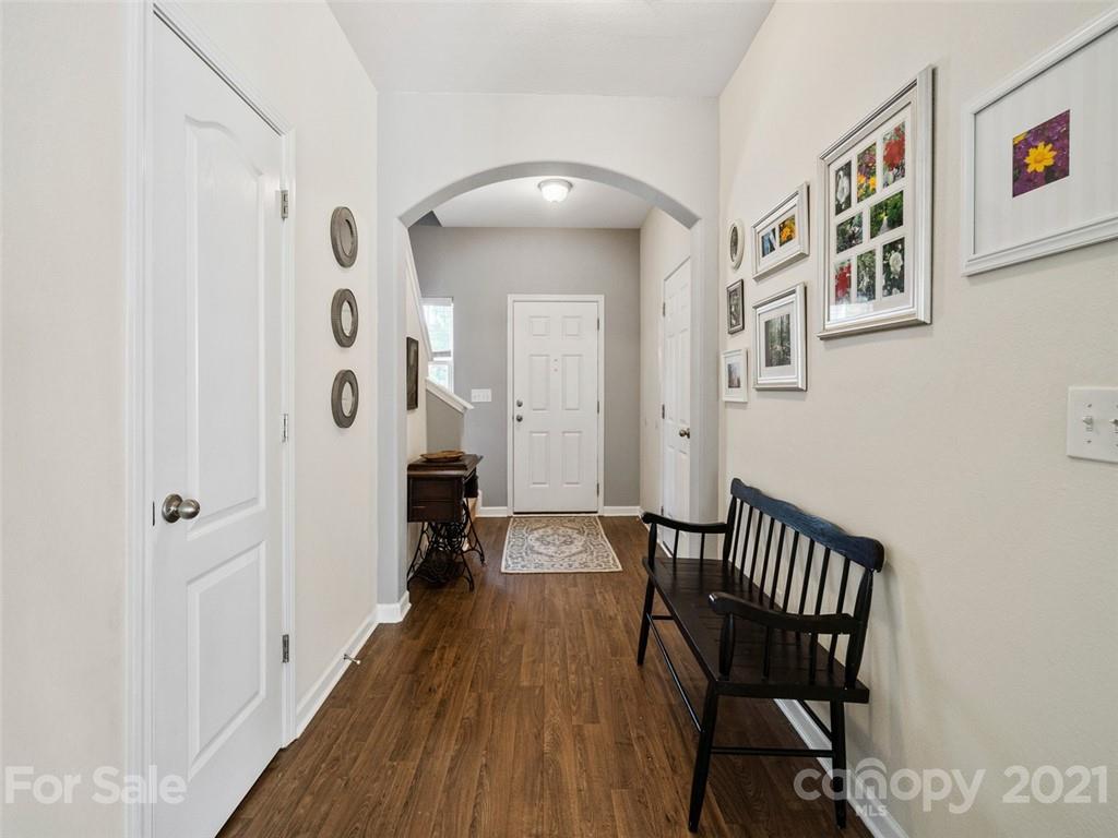 6823 Ware Road Charlotte, NC 28212 - Photo 5 of 47 a view of a hallway to a livingroom with furniture and hardwood floor