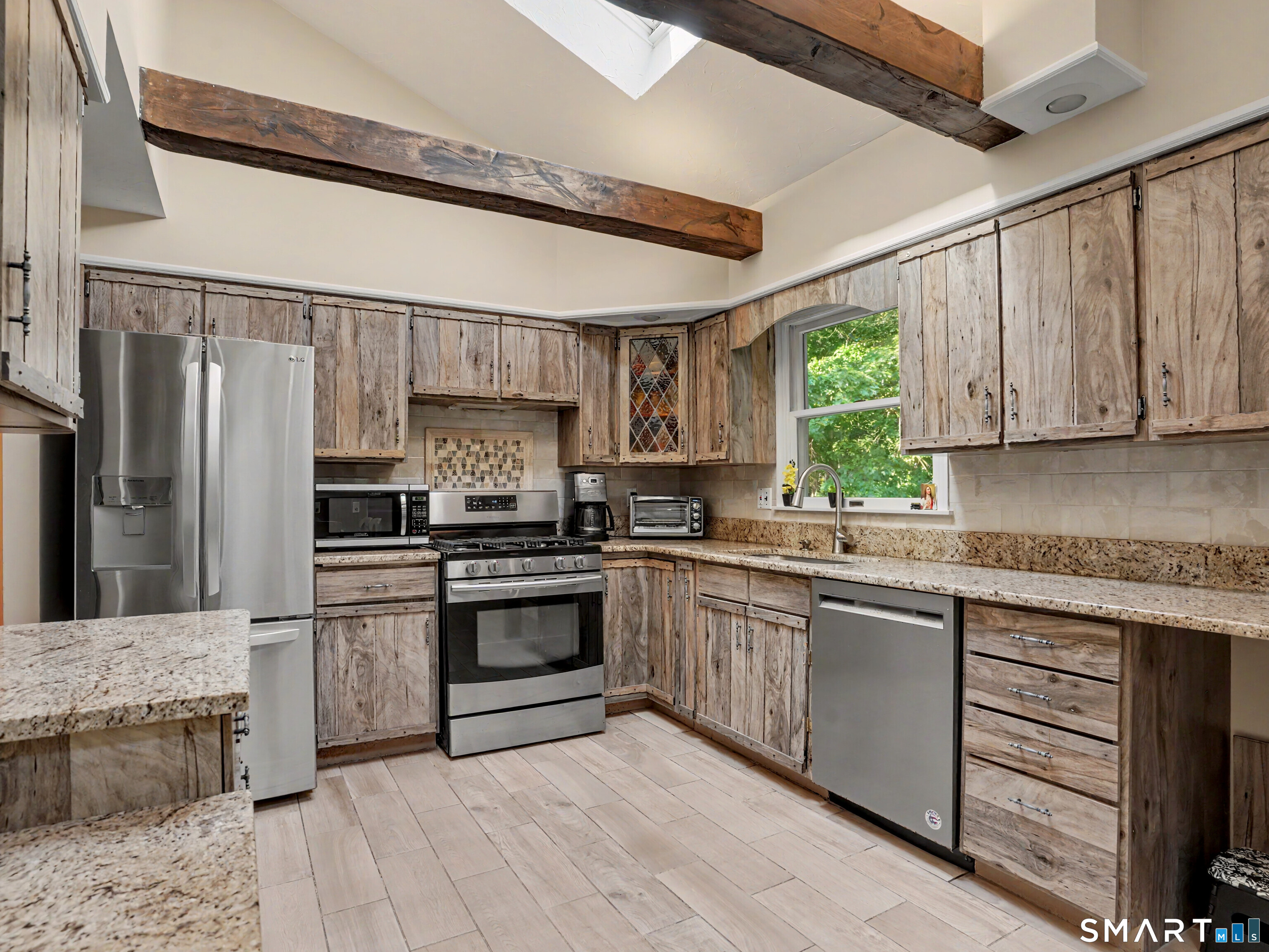 15 Flat Rock Drive Ridgefield, CT 06877 - Photo 15 of 39 a kitchen with stainless steel appliances granite countertop a stove a sink dishwasher a refrigerator and a microwave oven