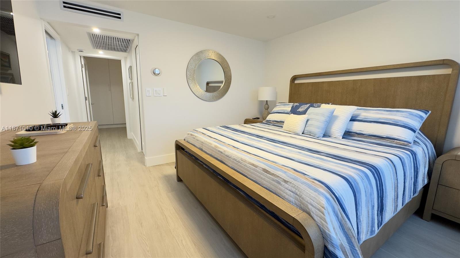 5161 Collins Avenue, Unit 715 Miami Beach, FL 33140 - Photo 14 of 31 a bedroom with a bed a mirror and desk