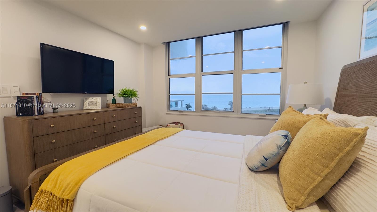 5161 Collins Avenue, Unit 715 Miami Beach, FL 33140 - Photo 16 of 31 a bedroom with a bed and a flat screen tv