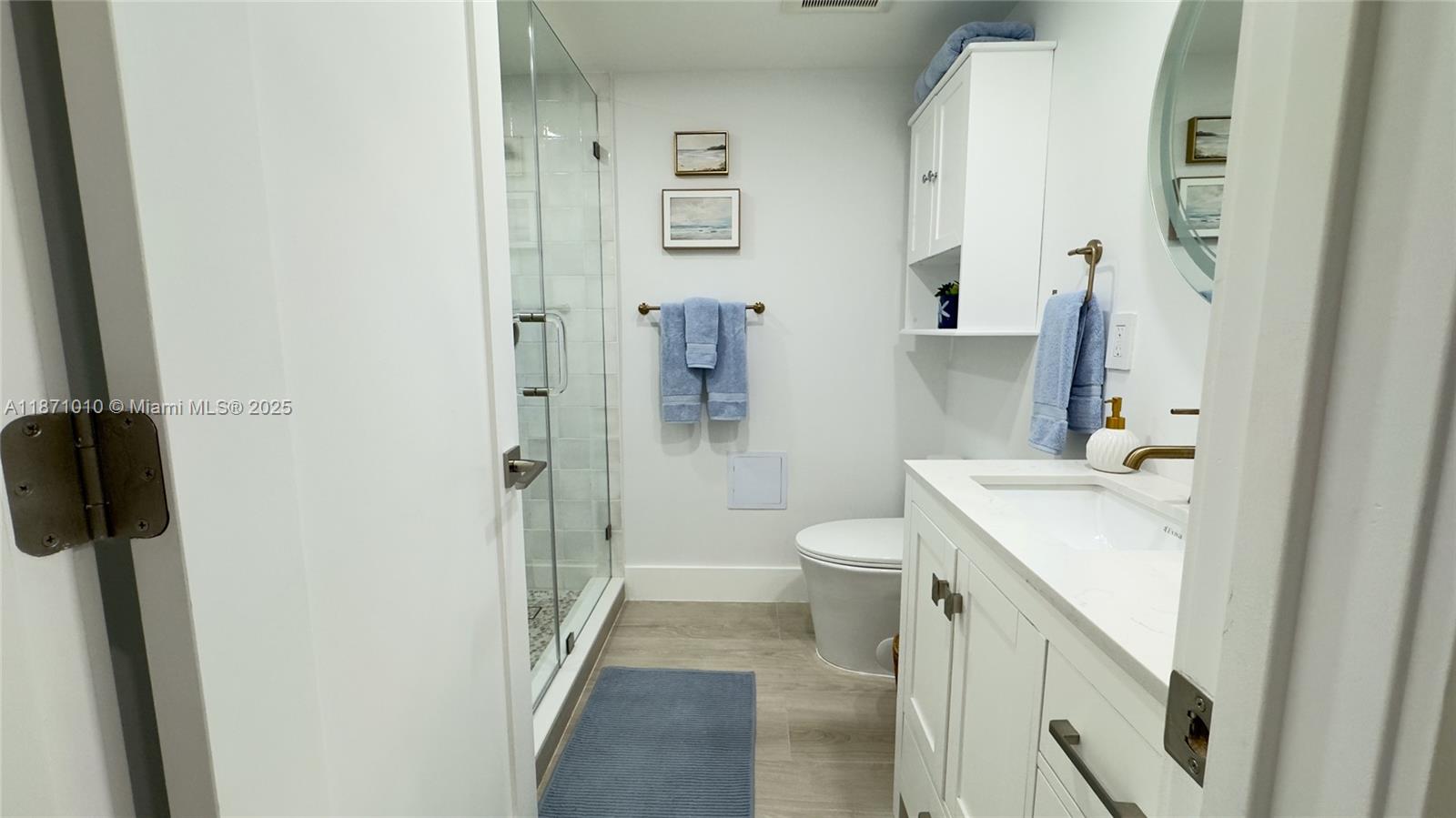 5161 Collins Avenue, Unit 715 Miami Beach, FL 33140 - Photo 17 of 31 a bathroom with a sink a toilet and shower