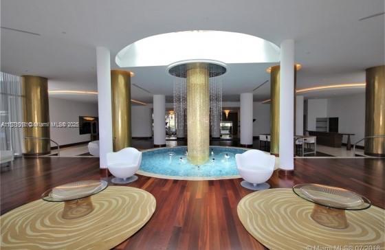 5161 Collins Avenue, Unit 715 Miami Beach, FL 33140 - Photo 18 of 31 a living room with furniture and a wooden floor