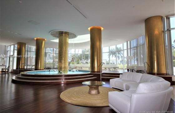 5161 Collins Avenue, Unit 715 Miami Beach, FL 33140 - Photo 20 of 31 a living room with furniture and a large window