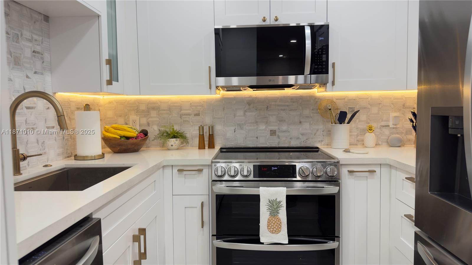 5161 Collins Avenue, Unit 715 Miami Beach, FL 33140 - Photo 2 of 31 a kitchen with a stove and a sink