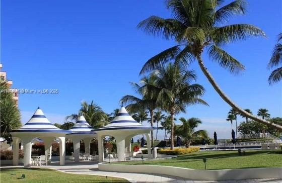 5161 Collins Avenue, Unit 715 Miami Beach, FL 33140 - Photo 24 of 31 a view of a white house with a yard table and chairs