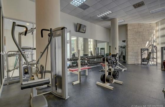 5161 Collins Avenue, Unit 715 Miami Beach, FL 33140 - Photo 30 of 31 a view of a room with gym equipment