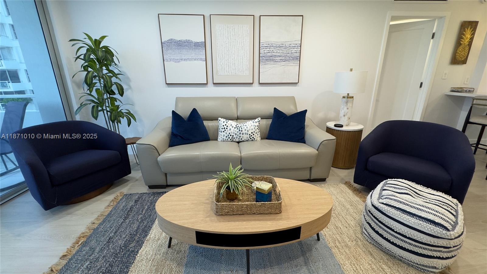 5161 Collins Avenue, Unit 715 Miami Beach, FL 33140 - Photo 7 of 31 a living room with furniture and a potted plant