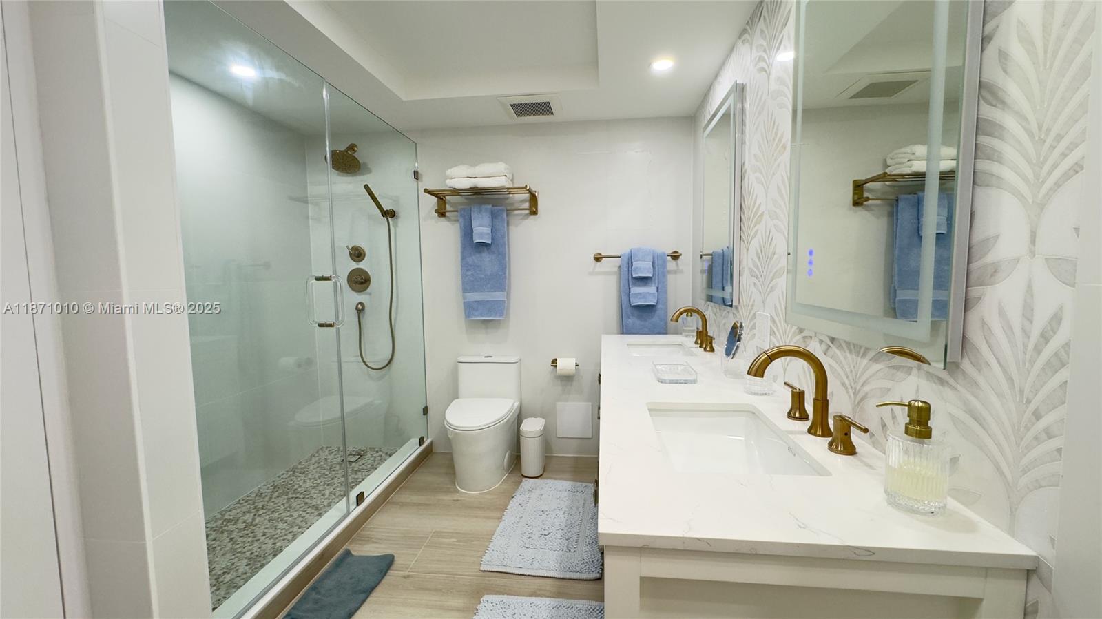 5161 Collins Avenue, Unit 715 Miami Beach, FL 33140 - Photo 10 of 31 a bathroom with a sink toilet and shower