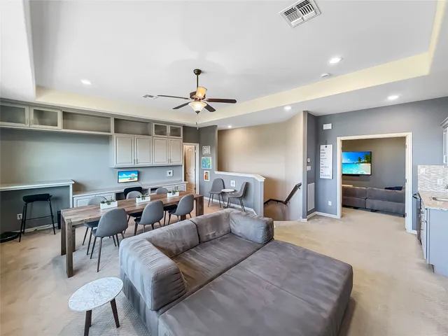 a living room with furniture and kitchen view
