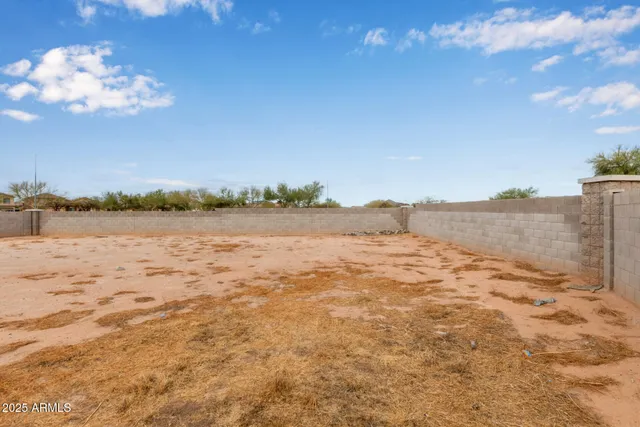 a front view of a house with a dirt yard