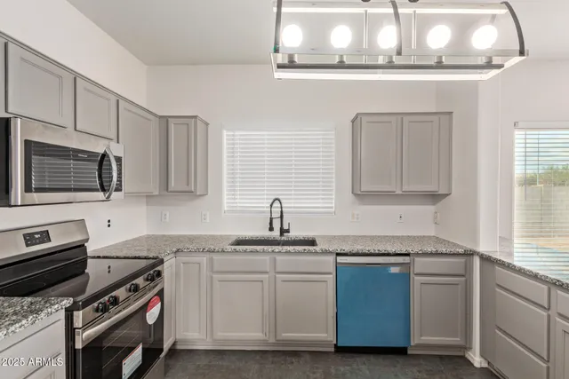 a view of a kitchen with a sink and stainless steel appliances