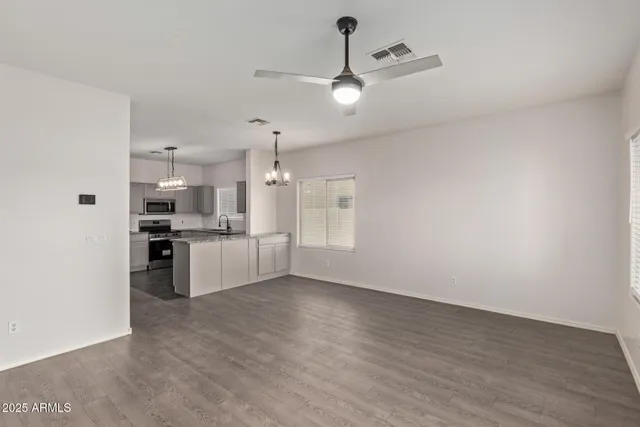 a view of a kitchen with refrigerator and white cabinets