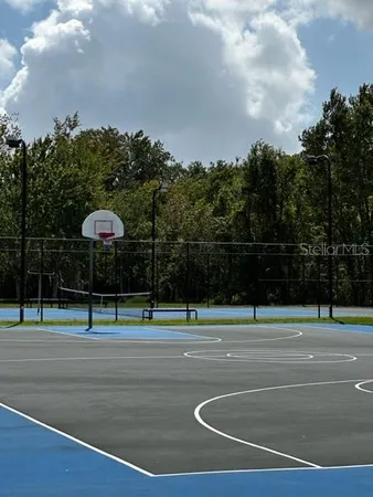 a view of a tennis ground with trees